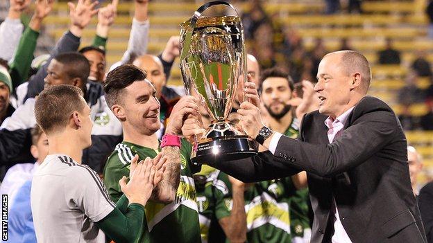 Ridgewell lifts the MLS Cup with Portland Timbers owner Merritt Paulson in 2015