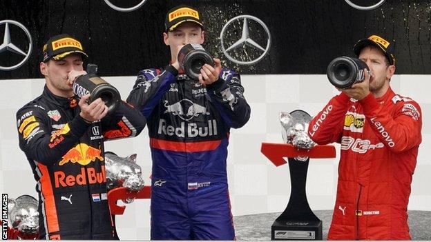 Max Verstappen, Sebastian Vettel and Daniil Kvyat drink champagne on the podium