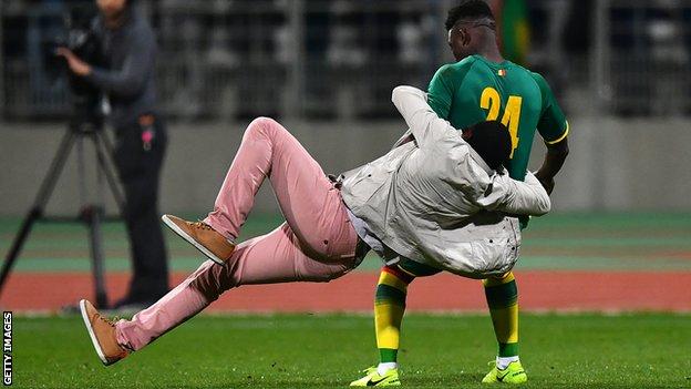 Senegal player Lamine Gassama was grabbed by a fan during the incident