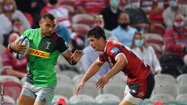 Harlequins centre Joe Marchant evades the tackle of Gloucester winger Louis Rees-Zammit during a Premiership match at Kingsholm