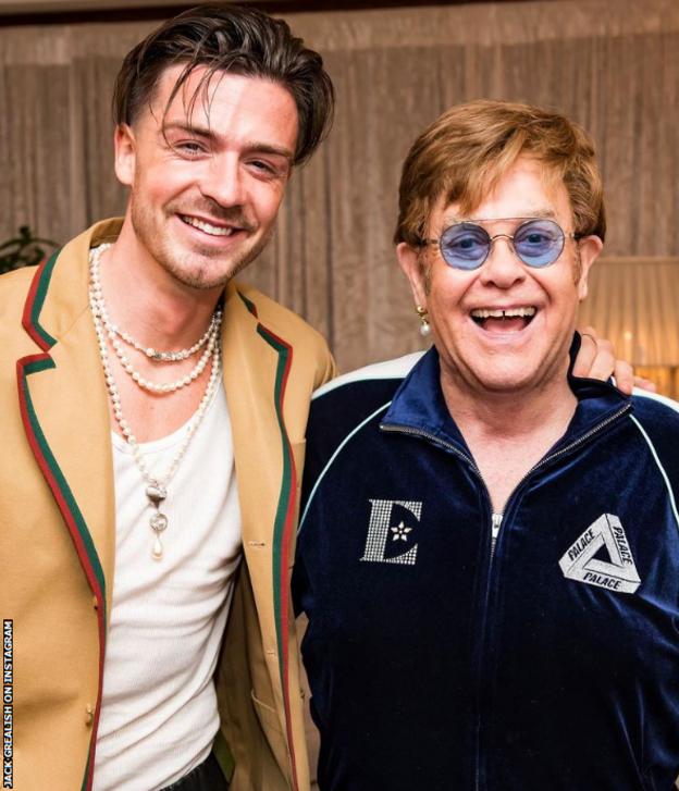 Manchester City's Jack Grealish poses for a photograph with Sir Elton John after a concert