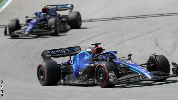 Williams drivers Nicholas Latifi and Alex Albon driving on track