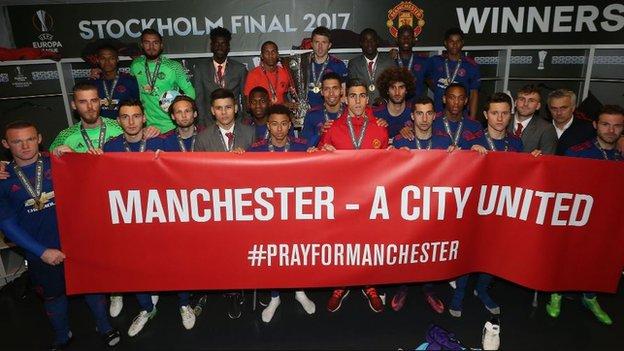 Manchester United players hold up a banner