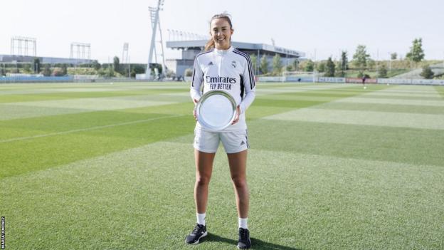 Caroline Weir at Real Madrid's training ground holding her award from the SFWA