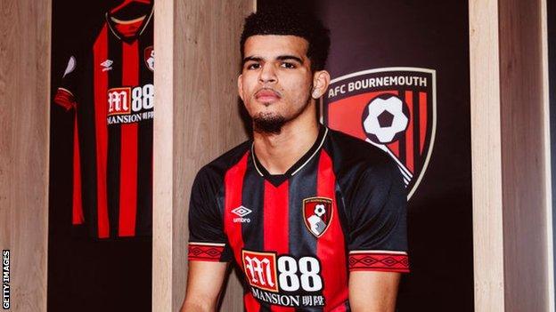 Striker Dominic Solanke sits wearing a Bournemouth shirt in the dressing room following his move from Liverpool
