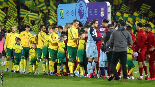 Norwich and Liverpool shake hands before their Premier League match