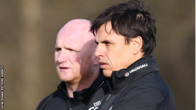 John Hartson (background) was part of the Wales backroom staff under ex-manager Chris Coleman