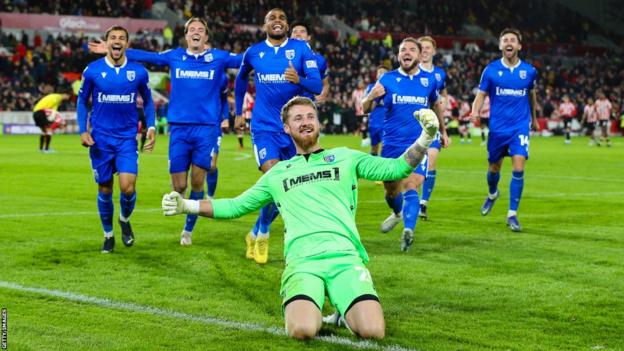 Gillingham's players celebrate after knocking Premier League Brentford out of the Carabao Cup on 8 November