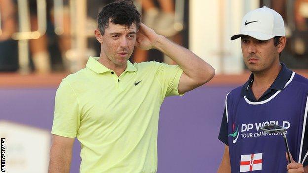 Rory McIlroy with caddie Harry Diamond on the 18th green in Dubai on Friday