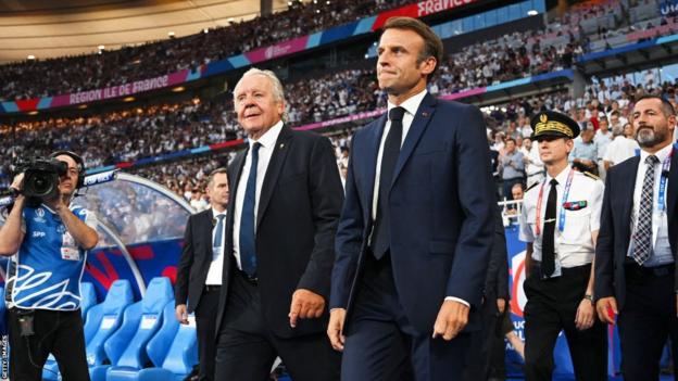 World Rugby chairman Bill Beaumont and French president Emmanuel Macron walk out into the Stade de France
