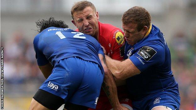 Hadleigh Parkes of Scarlets is tackled by Isa Nacewa and Sean Cronin of Leinster