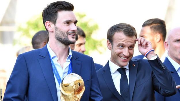 France captain Hugo Lloris (left) holds up the World Cup trophy next to French president Emmanuel Macron (right)