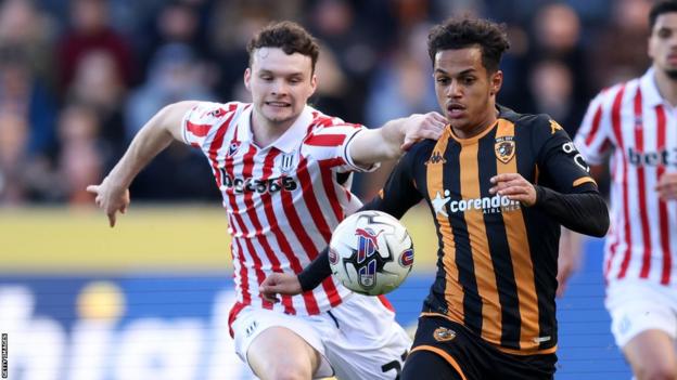 Fabio Carvalho of Hull City is challenged by Luke McNally of Stoke City during the Sky Bet Championship match between Hull City and Stoke City at MKM Stadium on March 29, 2024 in Hull, England.