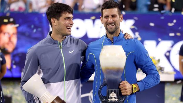 Carlos Alcaraz of Spain and Novak Djokovic of Serbia airs  with their trophies aft  the last  of the Western & Southern Open