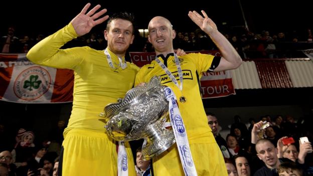 Cliftonville's Jaimie McGovern and Ryan Catney provide a reminder that the north Belfast club have won the League Cup for four successive seasons