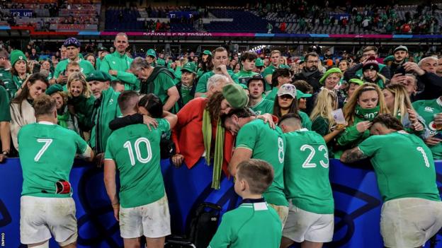 The Irish players are embraced by their loved ones