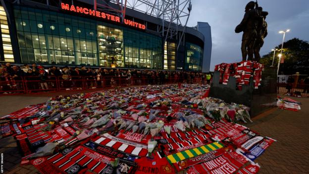 Scarves and flowers outside Old Trafford before Manchester United's first home game since the passing of club legend Sir Bobby Charlton