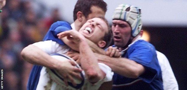 Matt Dawson is tackled round the neck by French players Olivier Magne and Fabien Galthie in a 2000 Six Nations game