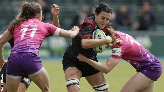Emma Taylor is tackled by two Loughborough players