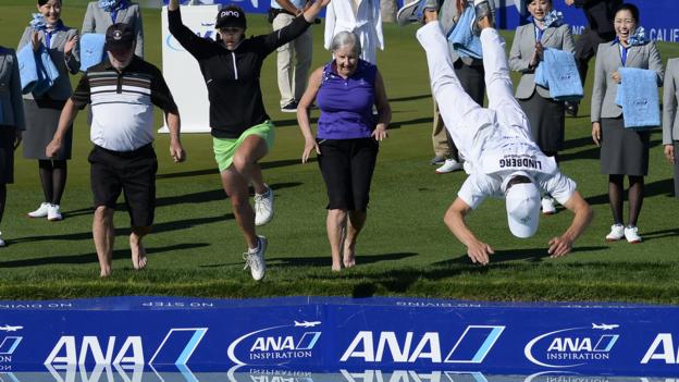 APRIL 02: Pernilla Lindberg of Sweden jumps into the water with her fiance Daniel Taylor and her parents Jan and Gunilla Lindberg after winning the the ANA Inspiration on the Dinah Shore Tournament Course at Mission Hills Country Club on April 2, 2018 in Rancho Mirage, California. (Photo by Robert Laberge/Getty Images)