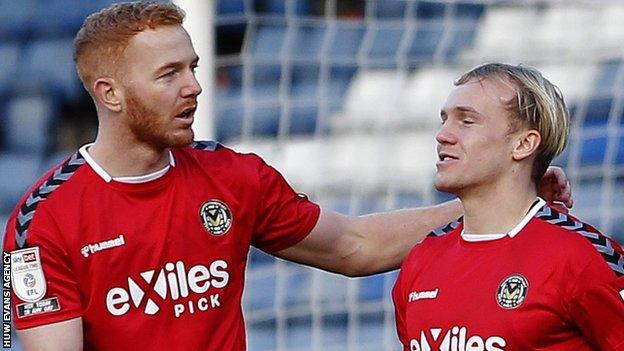 Newport's Jack Scrimshaw (R) celebrates scoring the opening goal at Oldham with Ryan Taylor