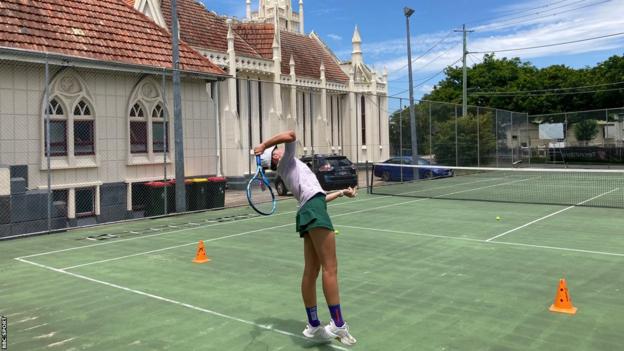 Liv Wood serving during a practice session in Brisbane