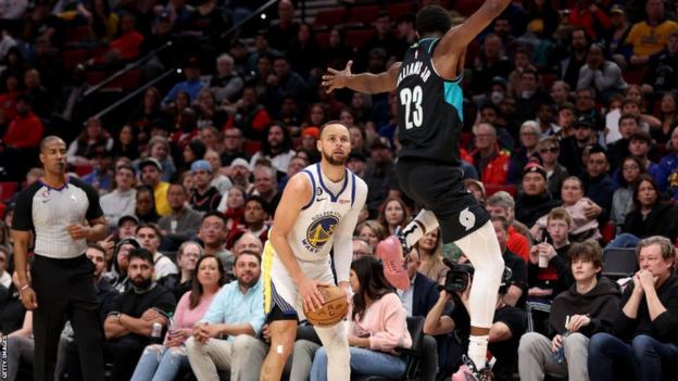 Stephen Curry of the Golden State Warriors waits to shoot a three-point attempt against the Portland Trail Blazers