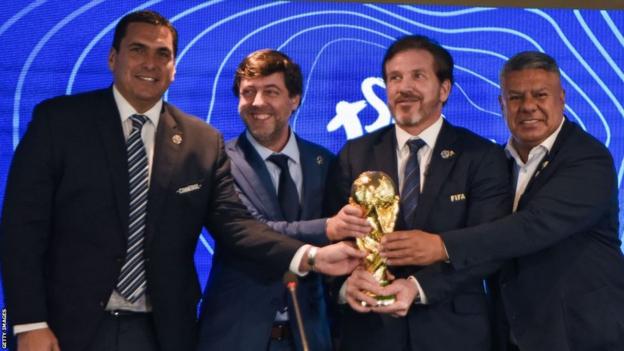 Paraguayan FA president Robert Harrison, Uruguayan FA president Ignacio Alonso, Conmebol president Alejandro Dominguez and Argentine FA president Claudio Tapia hold a replica World Cup trophy