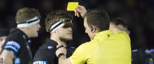 Glasgow Warriors hooker George Turner is shown a yellow card by referee Matthew Carley