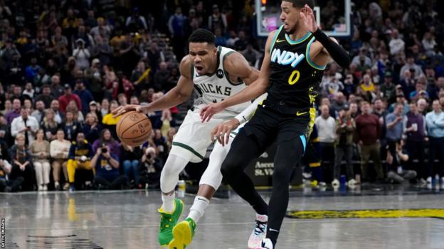 Giannis Antetokounmpo of the Milwaukee Bucks bounces the ball on the floor during their NBA match against the Indiana Pacers