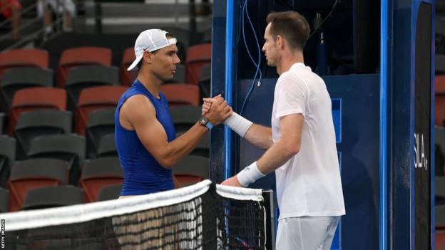 Rafael Nadal and Andy Murray shake hands at the net after training together