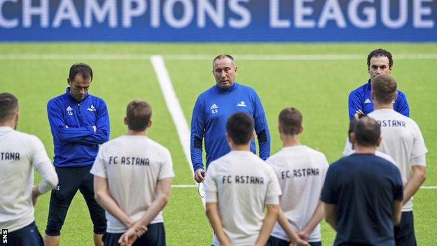 Astana coach Stanimir Stoilov (centre) addresses his players during training