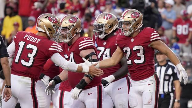 Christian McCaffrey celebrating his touchdown with Brock Purdy