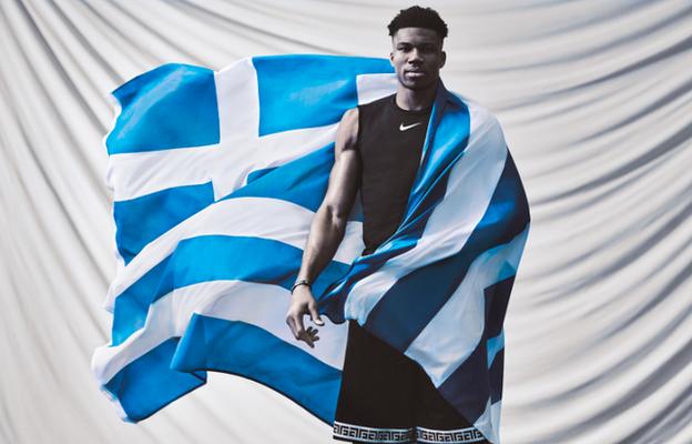 Giannis poses with a Greek flag for promotional Nike photoshoot