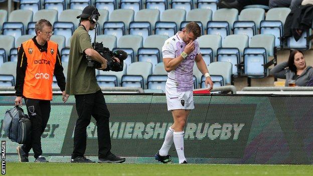 Dan Biggar of Northampton Saints walks off the pitch after being injured during the Gallagher Premiership Rugby match between Wasps and Northampton Saints at The Coventry Building Society Arena