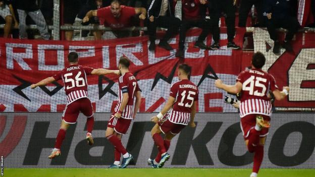Olympiakos players celebrate taking the lead against West Ham in the Europa League
