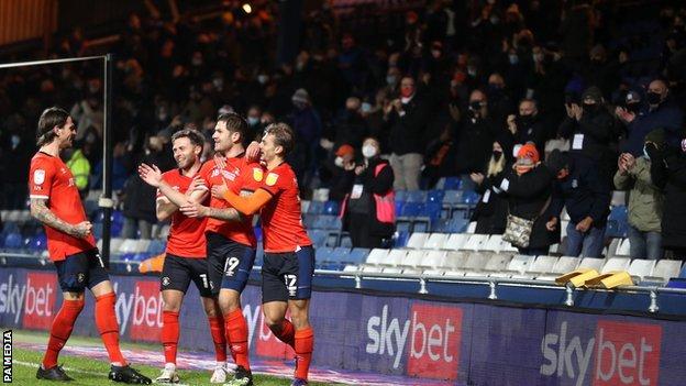 James Collins has scored four of his six goals this season at Kenilworth Road and all against Norwich City - but this was the first he has celebrated with the fans