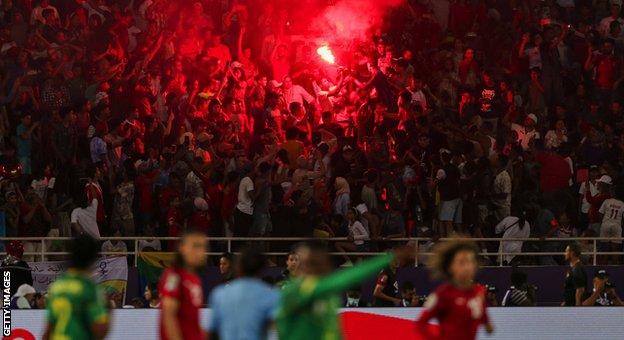 Morocco fans light a flare in the stands during the 2022 Women's Africa Cup of Nations final