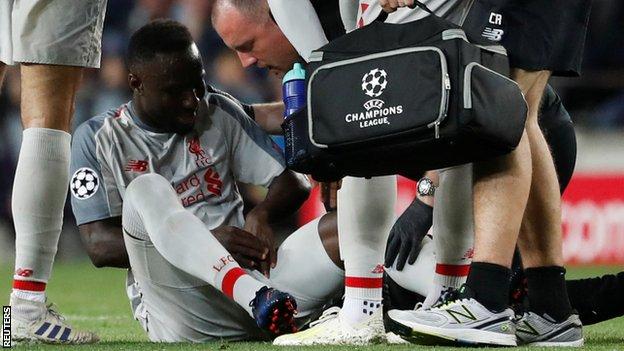 Liverpool midfielder Naby Keita receives treatment during the Champions League defeat at Barcelona