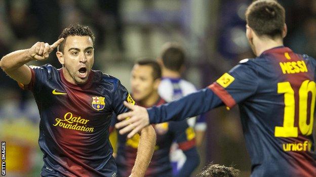 Xavi celebrates with then Barcelona team-mate Lionel Messi in 2012