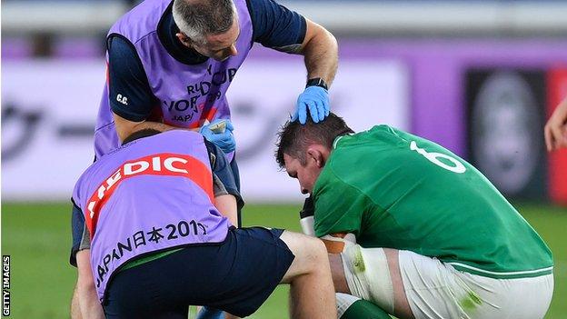 Peter O'Mahony receives treatment from Ireland medics during the win over Scotland