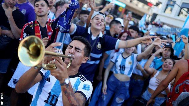 Argentina fans playing music and dancing in Buenos Aires