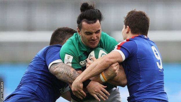 Ireland's James Lowe is tackled by France's Cyril Bailie and Antoine Dupont