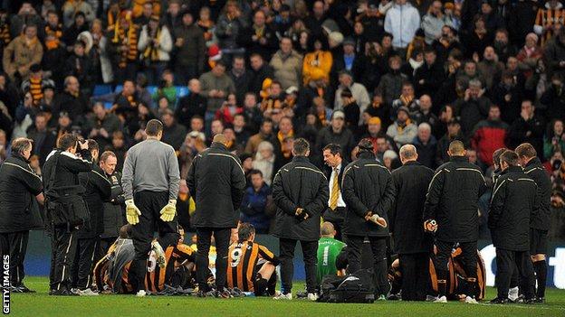 Phil Brown delivers his half-time teamtalk on the pitch at Etihad Stadium