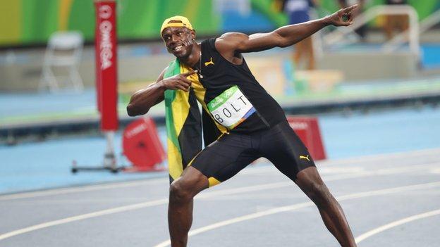 Usain Bolts celebrates with his signature lightning bolt pose