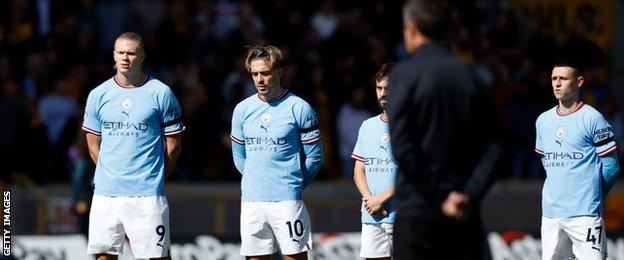 Manchester City take part in a minute's silence as a mark of respect for Queen Elizabeth II