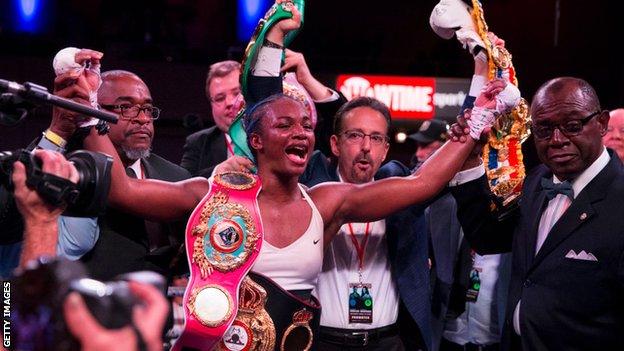 Claressa Shields celebrates with all her belts