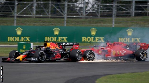 A Ferrari and a Red Bull collide during the British Grand Prix