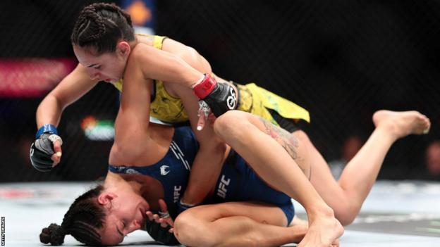 Casey O'Neill is punched by Ariane Lipski on the canvas