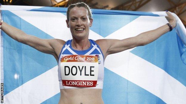 Eilidh Doyle celebrates with the Scotland flag after winning silver in the 400m hurdles